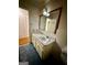 Bathroom with a vanity, a large mirror, and tiled floors and walls at 5730 Koweta Rd, South Fulton, GA 30349