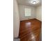 Simple bedroom with hardwood floors and natural light from a window at 5730 Koweta Rd, South Fulton, GA 30349