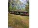 Charming single-story brick home with mature trees and colorful landscaping at 5730 Koweta Rd, South Fulton, GA 30349