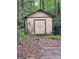 An outdoor shed with double doors and lighting is surrounded by dense trees and foliage at 5730 Koweta Rd, South Fulton, GA 30349