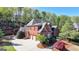 Beautiful brick home featuring a three-car garage and meticulously manicured landscaping at 10125 Brixton Pl, Suwanee, GA 30024