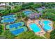 Aerial view of community with multiple tennis courts, swimming pools, and clubhouse at 10125 Brixton Pl, Suwanee, GA 30024