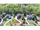 Estate aerial view showcasing lush landscaping, elegant home, and circular driveway at 10125 Brixton Pl, Suwanee, GA 30024