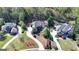 Expansive aerial view of a landscaped property featuring a luxurious home, pristine greenery, and a curving driveway at 10125 Brixton Pl, Suwanee, GA 30024
