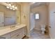 Traditional-style bathroom with large vanity, shower-tub combo, and tile flooring at 10125 Brixton Pl, Suwanee, GA 30024