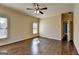 Bright bedroom featuring two windows, hardwood floors, and a ceiling fan at 10125 Brixton Pl, Suwanee, GA 30024