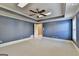 Bedroom features blue walls, carpet floors, and ceiling fan with lighting at 10125 Brixton Pl, Suwanee, GA 30024