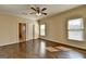 Bedroom featuring hardwood floors, bright natural light, and a ceiling fan at 10125 Brixton Pl, Suwanee, GA 30024