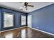Bedroom featuring hardwood floors, natural light, and neutral paint at 10125 Brixton Pl, Suwanee, GA 30024