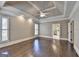 Bedroom featuring a tray ceiling, hardwood floors, and natural light at 10125 Brixton Pl, Suwanee, GA 30024
