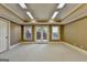 Carpeted bonus room featuring recessed lights and double doors to the backyard at 10125 Brixton Pl, Suwanee, GA 30024