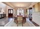 Charming dining room with a chandelier, double door entrance and sideboard at 10125 Brixton Pl, Suwanee, GA 30024