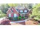 Stunning brick home featuring lush landscaping and a charming covered entryway at 10125 Brixton Pl, Suwanee, GA 30024