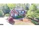 Beautiful brick home with manicured landscaping and a welcoming front porch at 10125 Brixton Pl, Suwanee, GA 30024