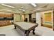 Finished basement game room featuring a billiards table, a ceiling fan, and a wet bar at 10125 Brixton Pl, Suwanee, GA 30024
