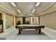 Basement game room featuring a billiards table, a ceiling fan, and barstool seating at 10125 Brixton Pl, Suwanee, GA 30024