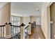 Upstairs hallway featuring hardwood floors and decorative railings at 10125 Brixton Pl, Suwanee, GA 30024