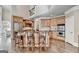 Spacious kitchen features an island with bar seating, stainless steel appliances, and hardwood flooring at 10125 Brixton Pl, Suwanee, GA 30024