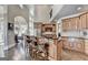Open concept kitchen with island, bar stools, stainless appliances, and connection to the dining area at 10125 Brixton Pl, Suwanee, GA 30024