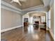Living room with hardwood floors, fireplace, and crown molding at 10125 Brixton Pl, Suwanee, GA 30024