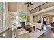 Bright living room featuring a fireplace, hardwood floors, and a view of the dining area at 10125 Brixton Pl, Suwanee, GA 30024