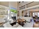 Bright living room featuring a fireplace, hardwood floors, and a view of the dining area at 10125 Brixton Pl, Suwanee, GA 30024