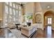 Bright living room featuring a fireplace, built-in bookshelves and a large bay window at 10125 Brixton Pl, Suwanee, GA 30024