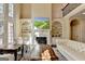 Bright living room featuring a fireplace, built-in bookshelves, hardwood floors, and a second-story view at 10125 Brixton Pl, Suwanee, GA 30024
