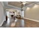 Open living room with hardwood floors, large archway, a fireplace, and an open concept at 10125 Brixton Pl, Suwanee, GA 30024