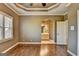 Bedroom with hardwood floors, natural light, and doorway to bathroom at 10125 Brixton Pl, Suwanee, GA 30024