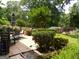 Tiled backyard patio with ample seating, mature landscaping, and lush greenery creating a peaceful outdoor oasis at 4213 Janice Drive, Atlanta, GA 30337