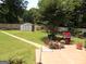 Spacious backyard with a lush lawn, storage shed, and outdoor grill, perfect for entertaining and relaxation at 4213 Janice Drive, Atlanta, GA 30337