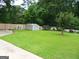 A spacious backyard with a shed, mature trees and well-maintained lawn for outdoor activities and relaxation at 4213 Janice Drive, Atlanta, GA 30337