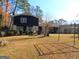 Spacious backyard featuring a patio area and mature trees, perfect for outdoor entertaining at 4213 Janice Drive, Atlanta, GA 30337