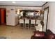 Home bar with seating, mirrored backdrop, and ample counter space for entertaining guests at 4213 Janice Drive, Atlanta, GA 30337