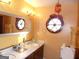 Bathroom with double sink vanity and a round window at 4213 Janice Drive, Atlanta, GA 30337
