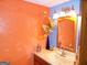 Unique bathroom featuring textured walls and a vanity with framed mirror at 4213 Janice Drive, Atlanta, GA 30337