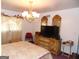 Bedroom featuring plush bedding, soft lighting, and a wooden dresser at 4213 Janice Drive, Atlanta, GA 30337