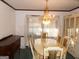 Formal dining room featuring a chandelier, table with seating for eight, and custom hutch at 4213 Janice Drive, Atlanta, GA 30337