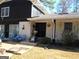 The house features a mix of brick and dark wood siding, with a covered porch at 4213 Janice Drive, Atlanta, GA 30337