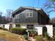 A view of the home, displaying a unique design with a combination of textures and a neatly kept garden at 4213 Janice Drive, Atlanta, GA 30337