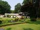 Charming single-Gathering home featuring a beautifully landscaped front yard with mature trees and colorful flowerbeds at 4213 Janice Drive, Atlanta, GA 30337