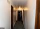 Well-lit hallway with multiple doorways, providing access to different areas of the home at 4213 Janice Drive, Atlanta, GA 30337