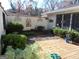 Private brick patio area featuring tasteful landscaping and a decorative art wall at 4213 Janice Drive, Atlanta, GA 30337