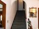 Classic staircase featuring carpeted steps and decorative mirror, leading to the upper level at 4213 Janice Drive, Atlanta, GA 30337