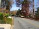 Neighborhood street view in front of the property, showcasing mature trees and a peaceful setting at 4213 Janice Drive, Atlanta, GA 30337