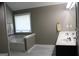 Elegant bathroom featuring a soaking tub and double vanity with neutral color palette at 419 Tea Rose N Ln, Stockbridge, GA 30281