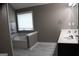 Elegant bathroom featuring a soaking tub and double vanity with neutral color palette at 419 Tea Rose N Ln, Stockbridge, GA 30281