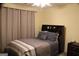 Cozy bedroom with neutral tones features a comfortable bed and matching nightstand at 419 Tea Rose N Ln, Stockbridge, GA 30281
