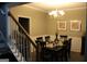 Formal dining room features elegant chandelier, table with seating for eight, and tasteful decor at 419 Tea Rose N Ln, Stockbridge, GA 30281